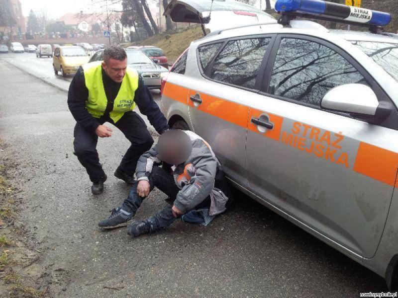 Strażnik miejski musi sprawdzić, co stało się mężczyźnie siedzącemu na chodniku / SM Wodzisław